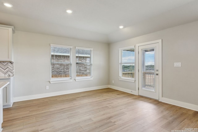 12734 Tegea Pass, San Antonio, TX 78245 - unfurnished dining area featuring light wood-type flooring, baseboards, and recessed lighting
