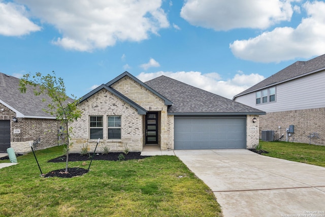 12734 Tegea Pass, San Antonio, TX 78245 - view of front of house featuring central AC unit, a garage, roof with shingles, driveway, and a front yard