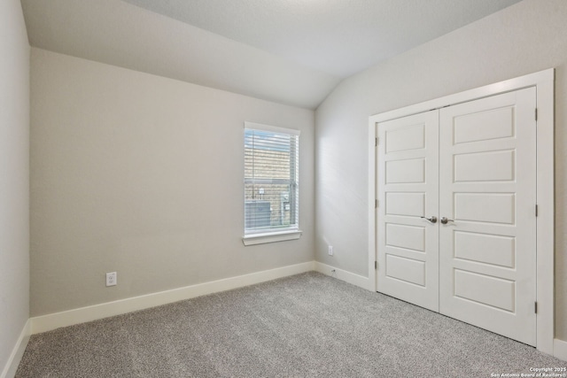 12734 Tegea Pass, San Antonio, TX 78245 - unfurnished bedroom with carpet, lofted ceiling, a closet, and baseboards