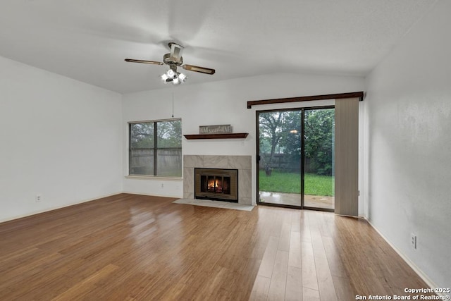 3807 Pine Breeze, San Antonio, TX 78247 - unfurnished living room with wood finished floors, ceiling fan, healthy amount of natural light, a tile fireplace, and vaulted ceiling