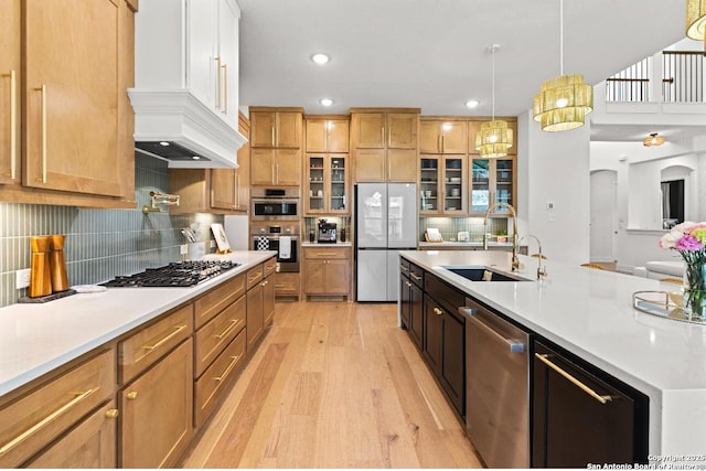 4003 Wood Crk, San Antonio, TX 78257 - kitchen with appliances with stainless steel finishes, a sink, light wood-type flooring, light countertops, and recessed lighting