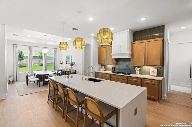 4003 Wood Crk, San Antonio, TX 78257 - kitchen with a sink, brown cabinets, light wood-type flooring, and recessed lighting