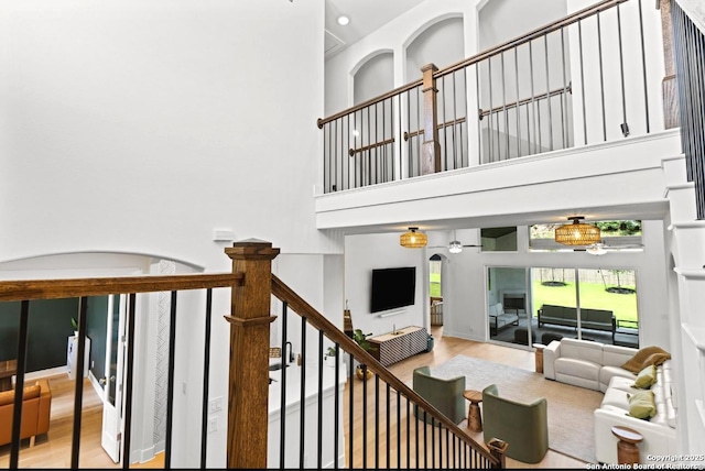 4003 Wood Crk, San Antonio, TX 78257 - stairway featuring wood finished floors, a towering ceiling, and recessed lighting