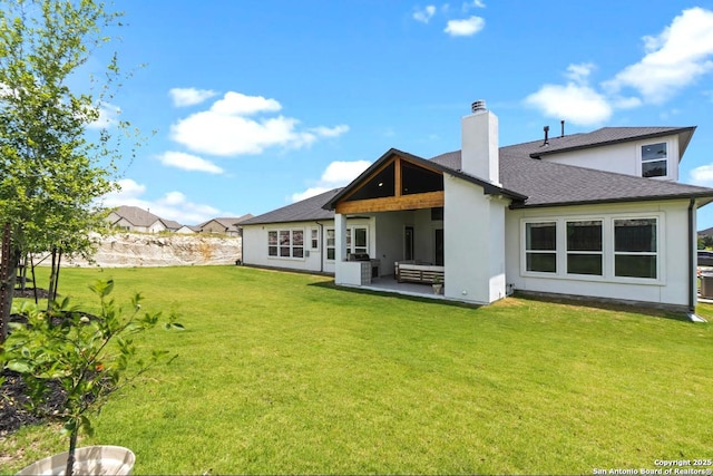 4003 Wood Crk, San Antonio, TX 78257 - back of property featuring a chimney, a lawn, a shingled roof, a patio, and stucco siding