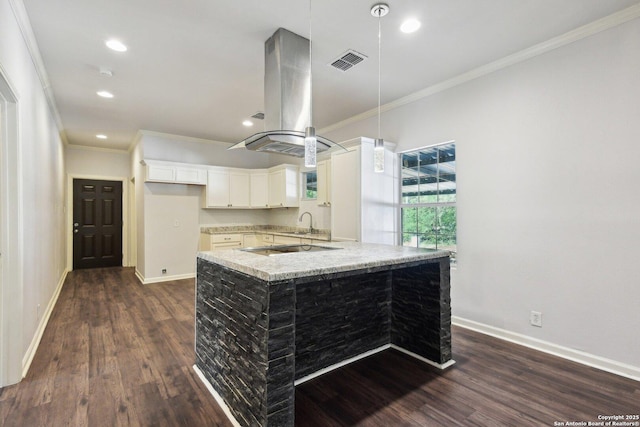 140 E Dullnig, San Antonio, TX 78223 - kitchen with island range hood, ornamental molding, dark wood-style floors, hanging light fixtures, and recessed lighting