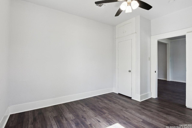 140 E Dullnig, San Antonio, TX 78223 - spare room with dark wood-type flooring, a ceiling fan, and baseboards