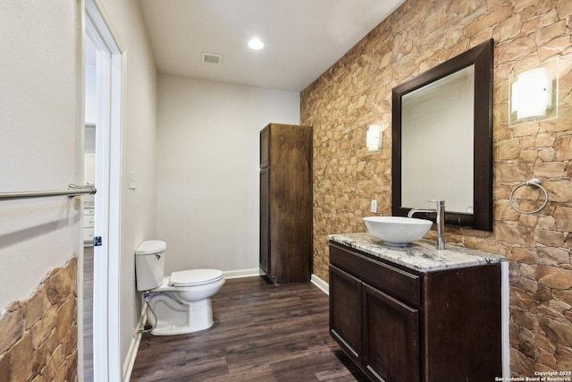 140 E Dullnig, San Antonio, TX 78223 - bathroom featuring toilet, vanity, wood finished floors, and baseboards