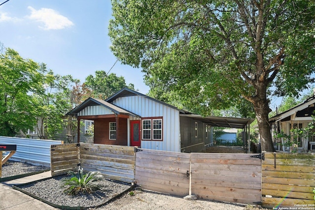 140 E Dullnig, San Antonio, TX 78223 - view of front of property with board and batten siding, a fenced front yard, and a porch