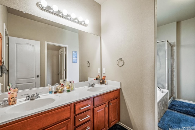 222 Red Quill Nest, San Antonio, TX 78253 - bathroom featuring double vanity, a shower, a tub, a textured wall, and baseboards