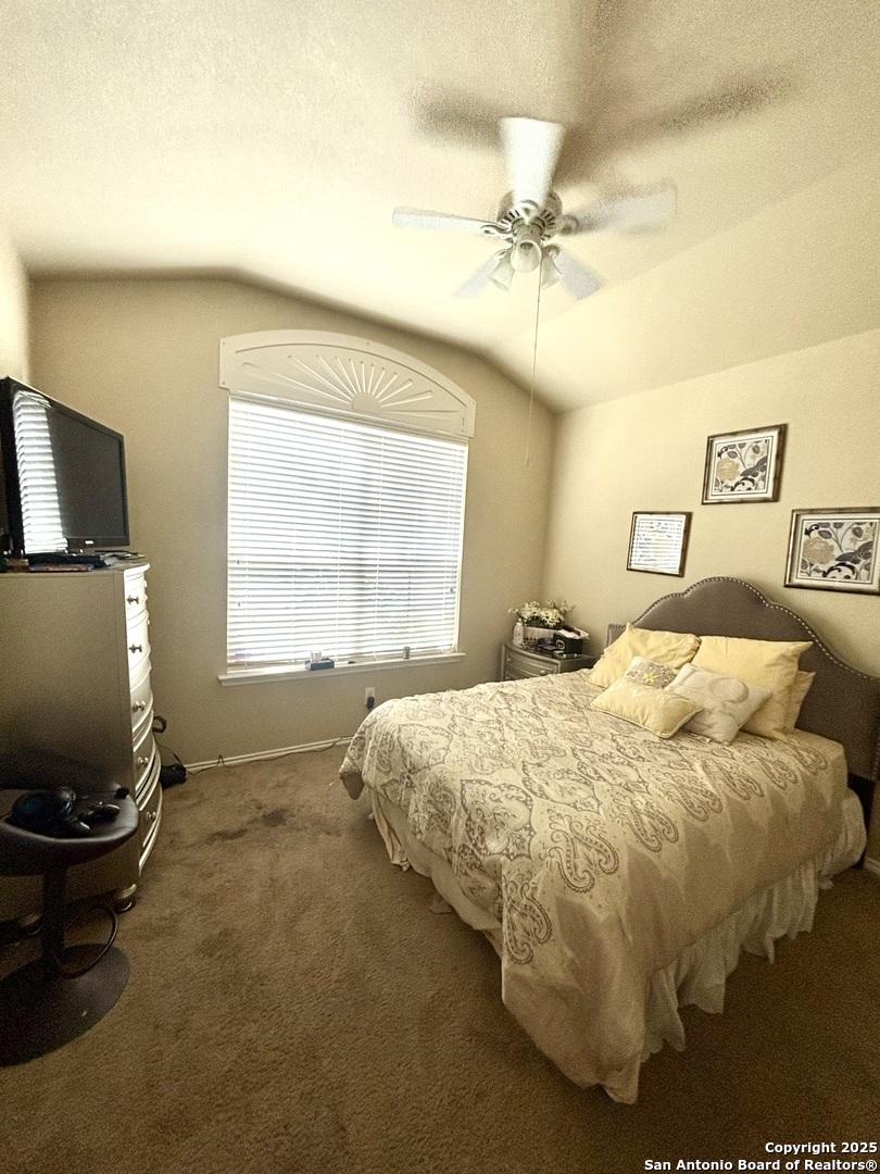 222 Red Quill Nest, San Antonio, TX 78253 - bedroom featuring vaulted ceiling, carpet flooring, baseboards, and a ceiling fan