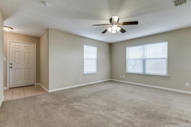 6046 Luckey Run, San Antonio, TX 78252 - spare room featuring light colored carpet, ceiling fan, a smoke detector, baseboards, and light tile patterned floors