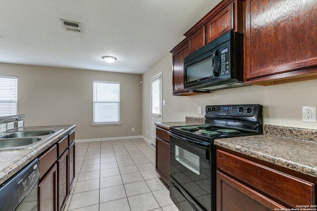6046 Luckey Run, San Antonio, TX 78252 - kitchen with black appliances, light tile patterned floors, baseboards, and a sink