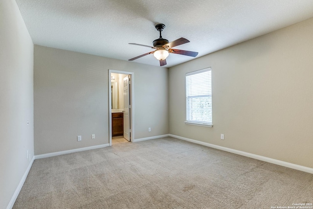 6046 Luckey Run, San Antonio, TX 78252 - spare room with a ceiling fan, light colored carpet, baseboards, and a textured ceiling