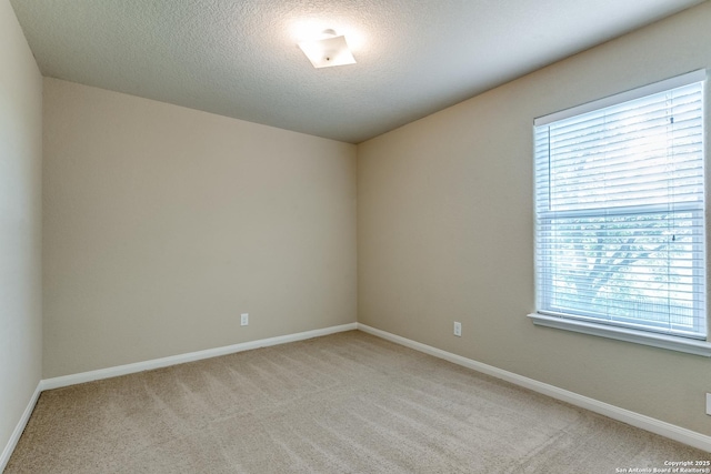 6046 Luckey Run, San Antonio, TX 78252 - unfurnished room featuring light colored carpet, a textured ceiling, and baseboards