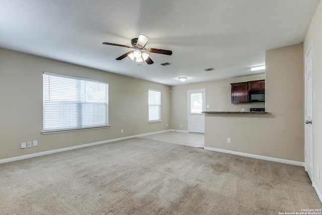 6046 Luckey Run, San Antonio, TX 78252 - unfurnished living room featuring light colored carpet, ceiling fan, and baseboards