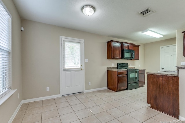 6046 Luckey Run, San Antonio, TX 78252 - kitchen with black appliances, light tile patterned floors, a sink, and baseboards