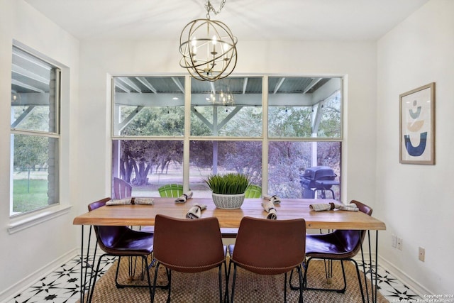 dining space with a chandelier and baseboards