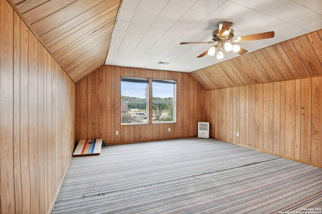 bonus room featuring carpet, wood walls, vaulted ceiling, and ceiling fan