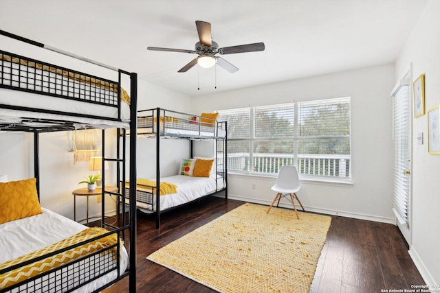 bedroom with baseboards, wood finished floors, and a ceiling fan