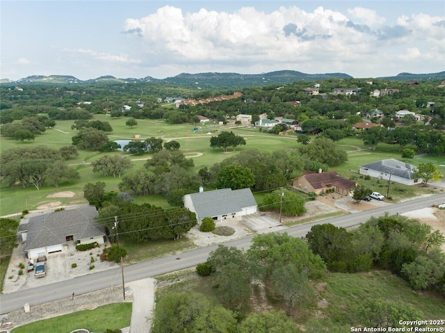 drone / aerial view of a golf club and a water and mountain view
