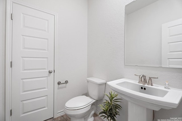 10836 Bango Farms, San Antonio, TX 78254 - bathroom featuring toilet and a textured wall