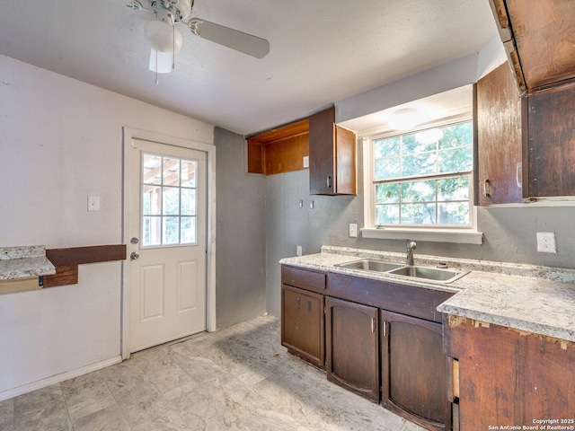 4330 Kilrea, San Antonio, TX 78219 - kitchen featuring a sink, ceiling fan, light countertops, and dark brown cabinetry