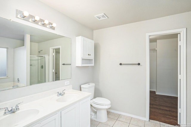 135 Blue Juniper, San Antonio, TX 78253 - bathroom featuring a stall shower, tile patterned floors, double vanity, toilet, and baseboards
