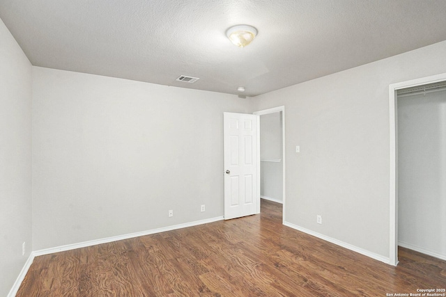 135 Blue Juniper, San Antonio, TX 78253 - unfurnished bedroom with wood finished floors, baseboards, a closet, and a textured ceiling