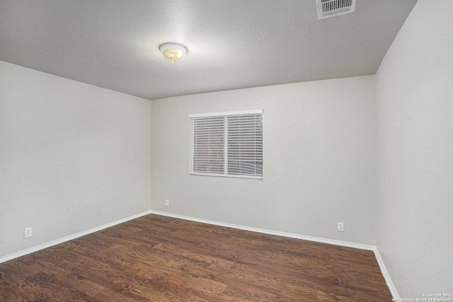 135 Blue Juniper, San Antonio, TX 78253 - spare room with dark wood-type flooring, baseboards, and a textured ceiling