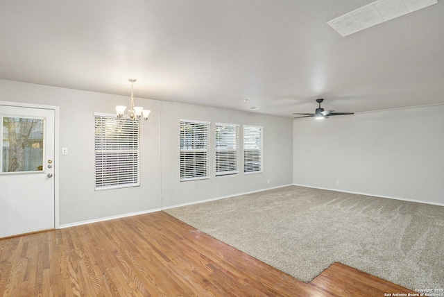 135 Blue Juniper, San Antonio, TX 78253 - unfurnished living room with a chandelier, ceiling fan, baseboards, and wood finished floors