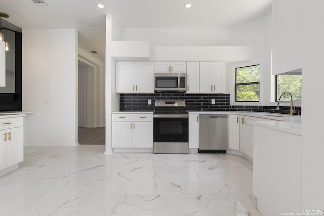16726 Burning Glade, San Antonio, TX 78247 - kitchen featuring appliances with stainless steel finishes, a sink, recessed lighting, backsplash, and white cabinets