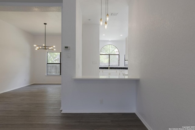 16726 Burning Glade, San Antonio, TX 78247 - unfurnished room featuring dark wood finished floors, a chandelier, and baseboards