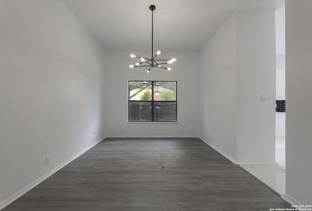 16726 Burning Glade, San Antonio, TX 78247 - unfurnished dining area with a chandelier, wood finished floors, vaulted ceiling, and baseboards
