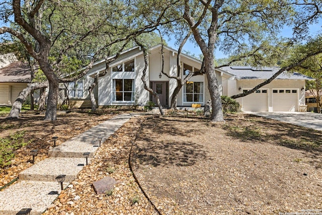 13018 Country Trl, San Antonio, TX 78216 - mid-century inspired home featuring roof mounted solar panels, concrete driveway, and a garage