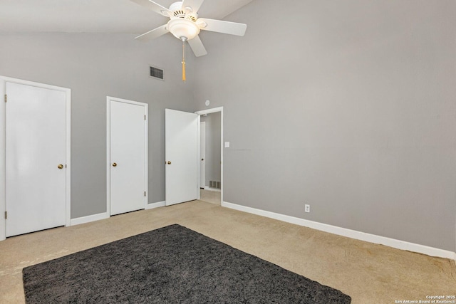 13018 Country Trl, San Antonio, TX 78216 - unfurnished bedroom featuring high vaulted ceiling, light colored carpet, baseboards, multiple closets, and a ceiling fan