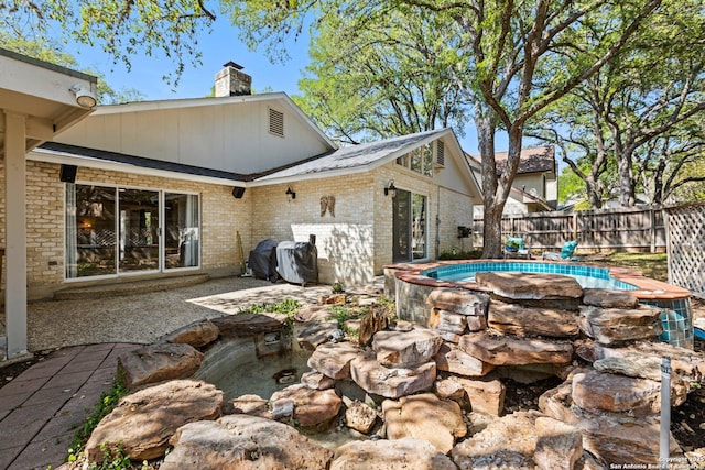 13018 Country Trl, San Antonio, TX 78216 - back of house with fence, a chimney, and a patio