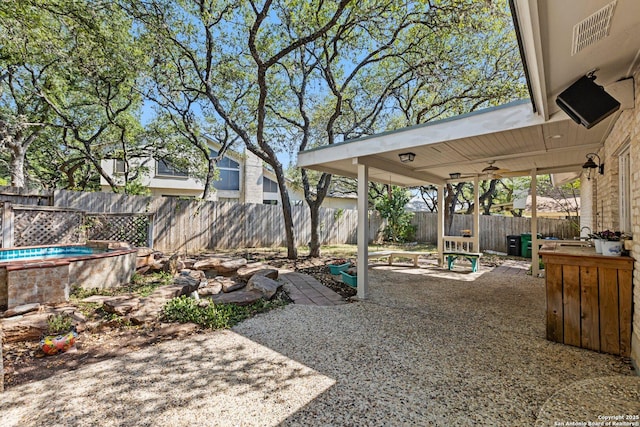 13018 Country Trl, San Antonio, TX 78216 - fenced backyard with a patio area and ceiling fan