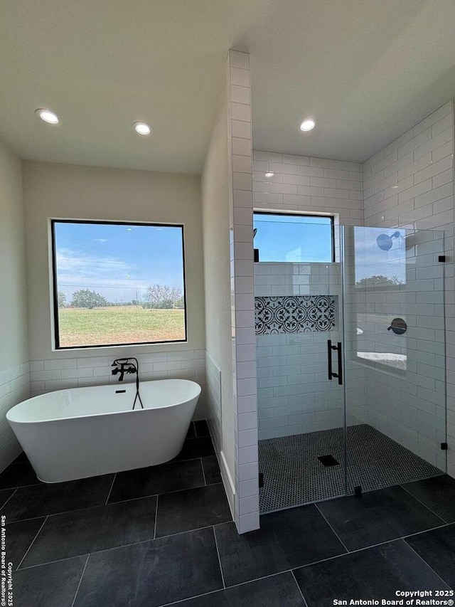 446 Waring Welfare, Boerne, TX 78006 - full bath featuring healthy amount of natural light, a freestanding tub, tile patterned flooring, a stall shower, and recessed lighting
