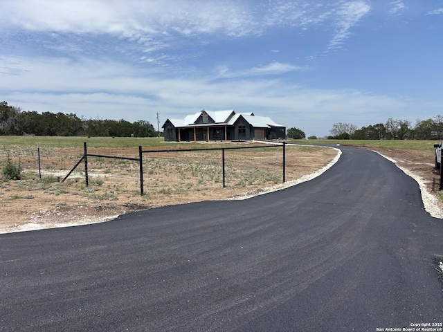 446 Waring Welfare, Boerne, TX 78006 - view of front of property with fence, driveway, and a rural view