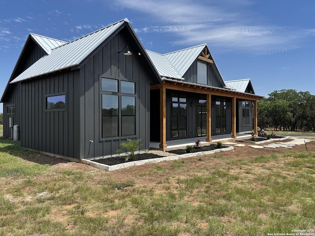 446 Waring Welfare, Boerne, TX 78006 - back of property featuring board and batten siding, metal roof, and a lawn