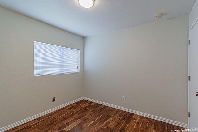 10202 Misty Pln, San Antonio, TX 78245 - unfurnished room featuring dark wood-style floors, baseboards, and a smoke detector