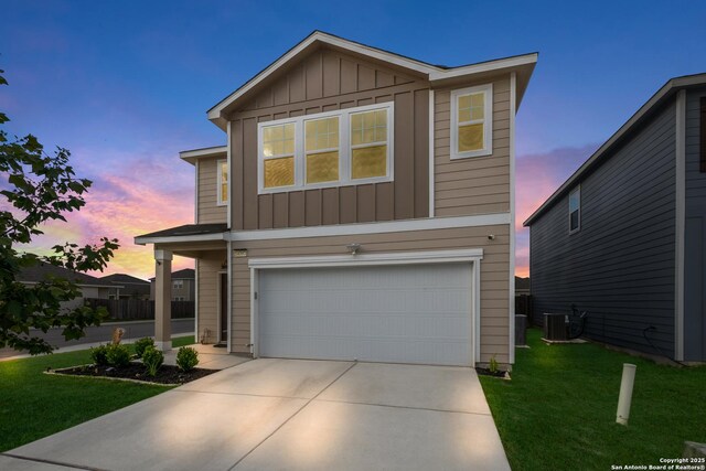14383 Palm Rdg, San Antonio, TX 78253 - view of front facade featuring board and batten siding, an attached garage, driveway, a front yard, and cooling unit