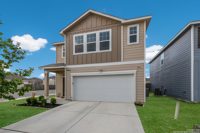 14383 Palm Rdg, San Antonio, TX 78253 - view of front of property featuring board and batten siding, a garage, driveway, a front yard, and central air condition unit