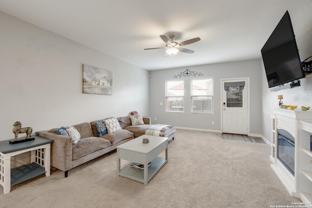 14383 Palm Rdg, San Antonio, TX 78253 - living area featuring a ceiling fan, carpet flooring, a glass covered fireplace, and baseboards