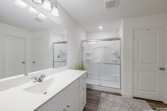 14383 Palm Rdg, San Antonio, TX 78253 - bathroom with wood finished floors, a stall shower, and vanity
