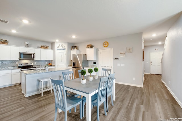 14383 Palm Rdg, San Antonio, TX 78253 - dining space featuring light wood finished floors, recessed lighting, and baseboards
