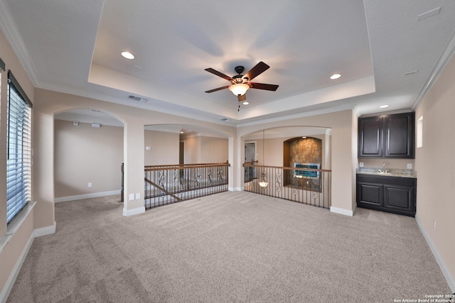 523 White Cyn, San Antonio, TX 78260 - unfurnished living room with a raised ceiling, ceiling fan, light carpet, recessed lighting, and arched walkways