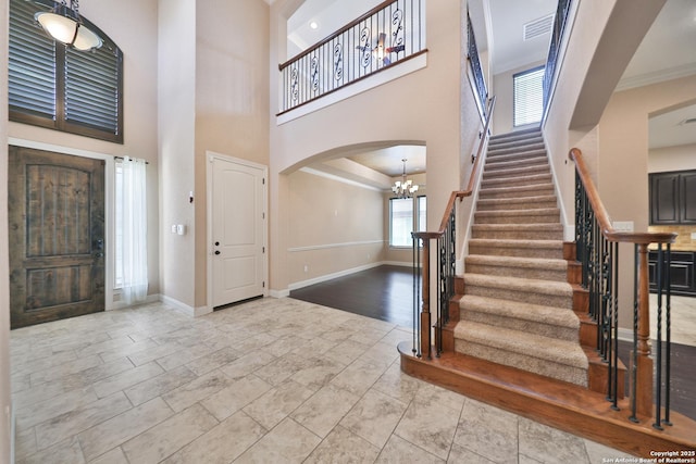 523 White Cyn, San Antonio, TX 78260 - foyer entrance featuring arched walkways, a high ceiling, stairs, baseboards, and a chandelier