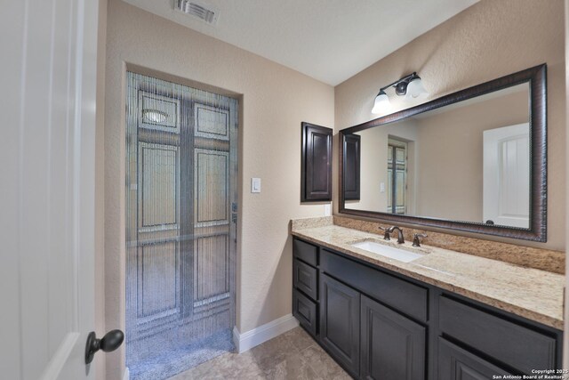 523 White Cyn, San Antonio, TX 78260 - bathroom featuring vanity, a textured wall, and baseboards