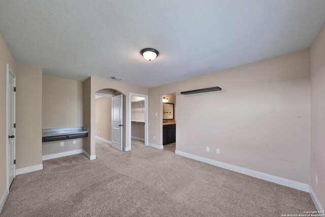 523 White Cyn, San Antonio, TX 78260 - empty room featuring arched walkways, carpet flooring, and baseboards